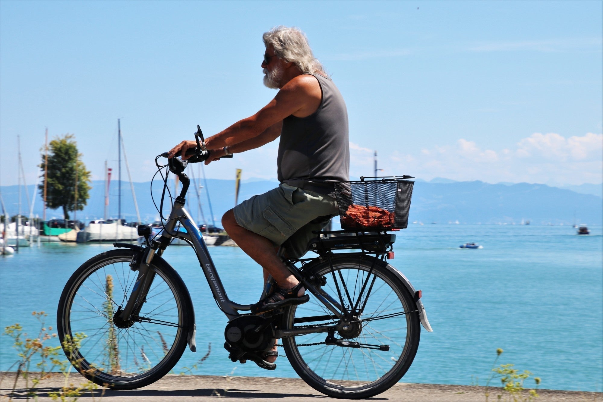 Man riding e-bike on beach.