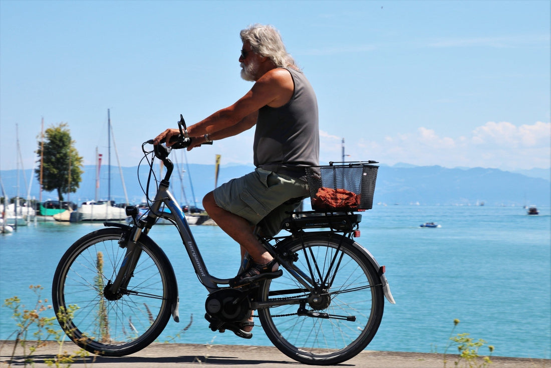 Man riding e-bike on beach.