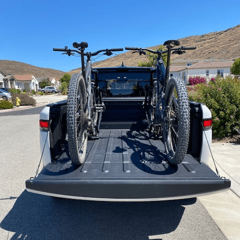 Rear view of two bikes in the bed of a truck using the QR3 Bike Rack for Rivian R1T.