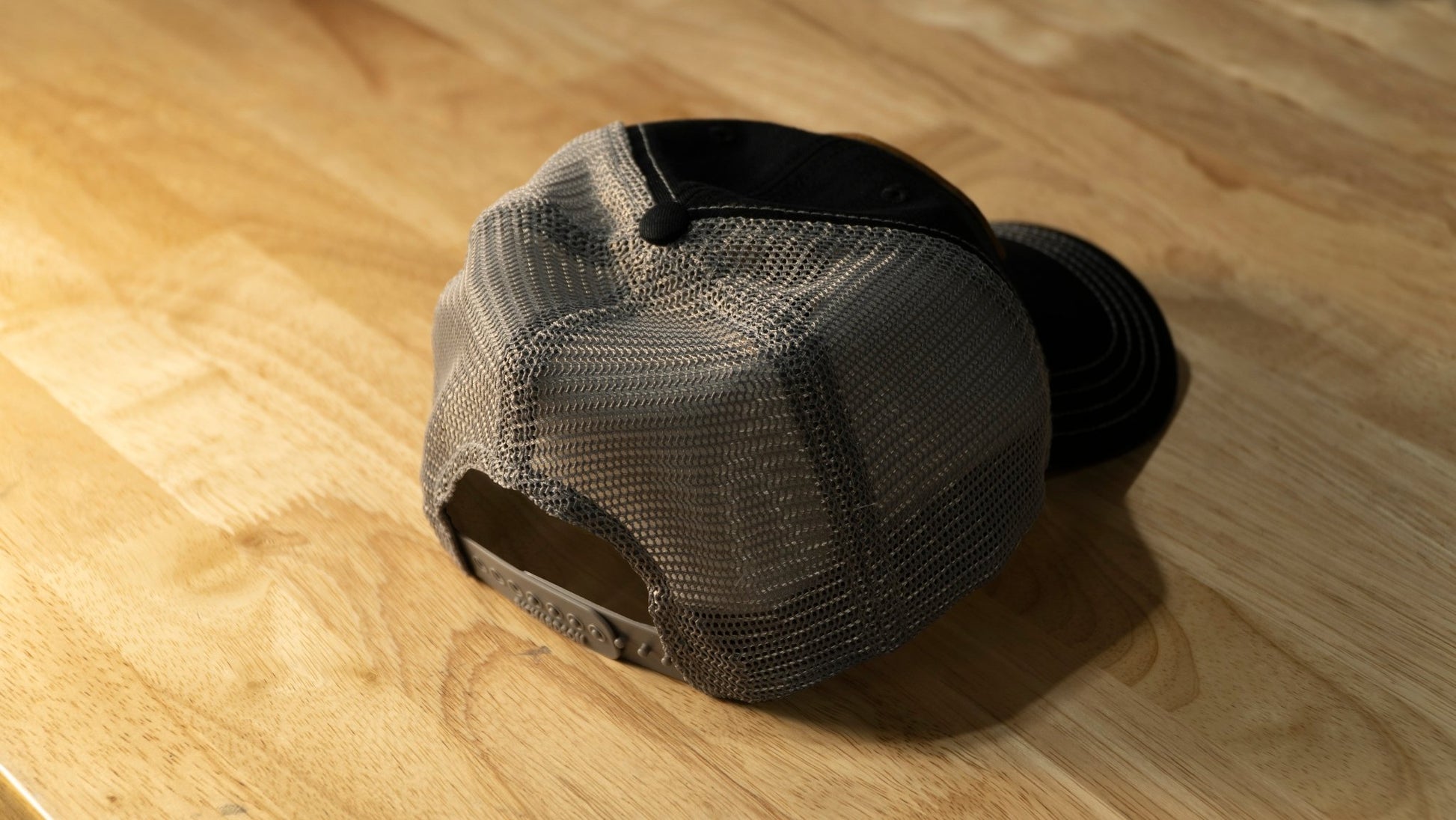 RIDE88 black and gray curved bill trucker hat with brown leather patch logo reading “RIDE88 Ultimate Truck Bike Racks,” featuring mesh back and contrast stitching.