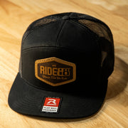 RIDE88 black trucker hat with brown leather patch logo reading “RIDE88 Ultimate Truck Bike Racks,” featuring flat bill and mesh back design.