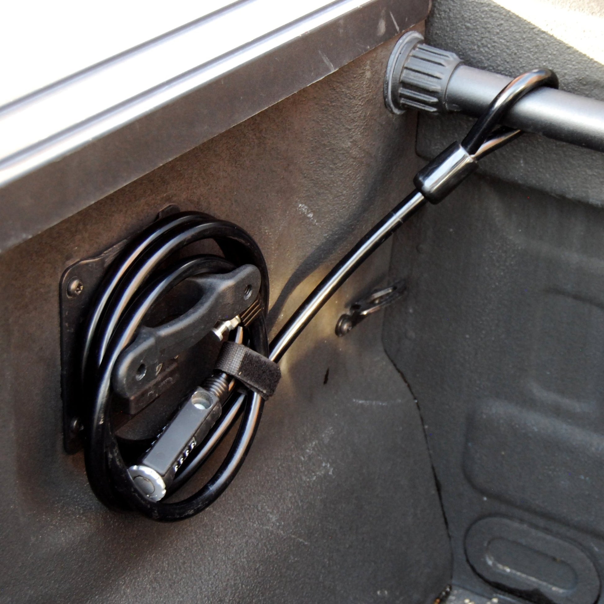 RIDE88 bicycle Cable Lock coiled around a mount in the truck bed, and attached to the crossbar.