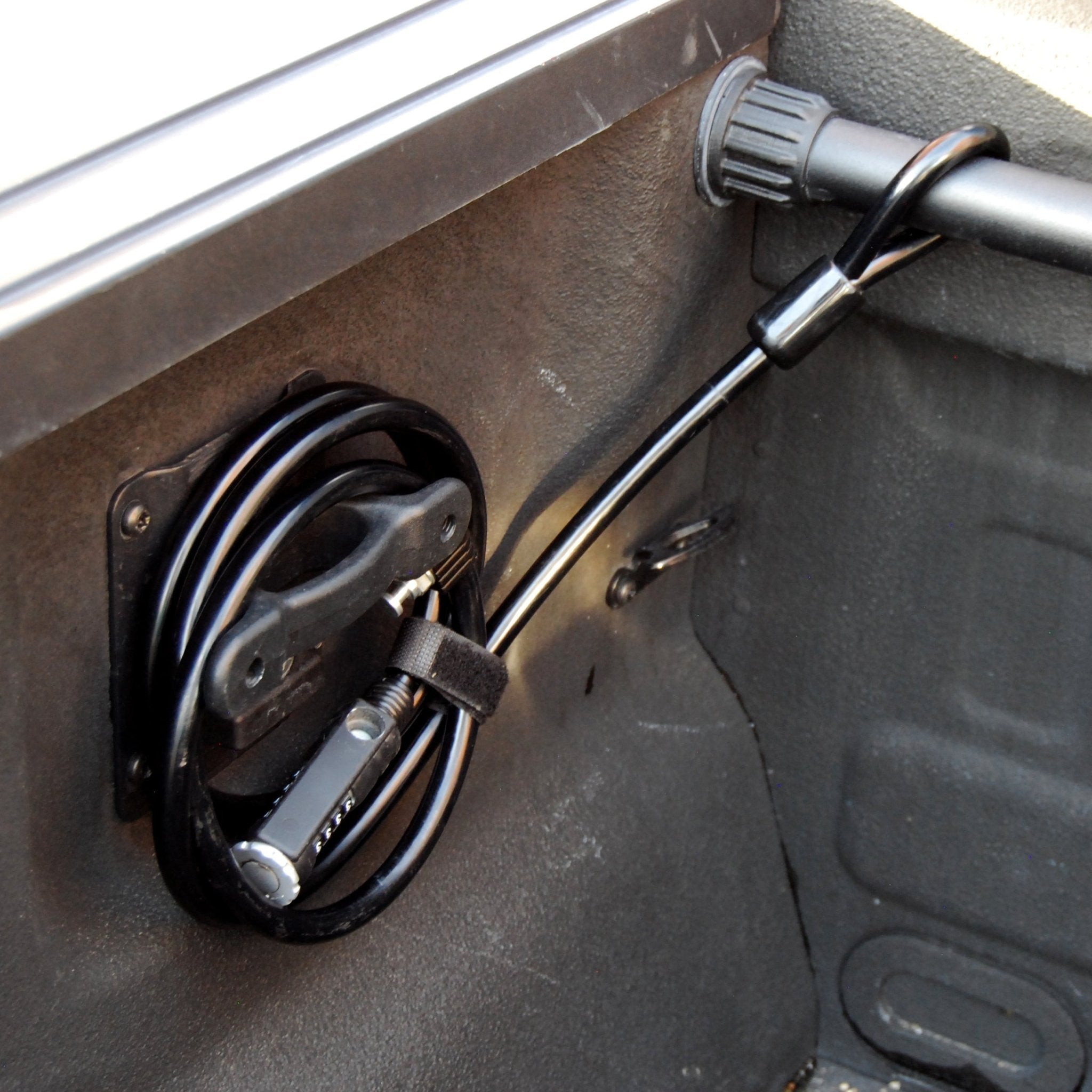 RIDE88 bicycle Cable Lock coiled around a mount in the truck bed, and attached to the crossbar.