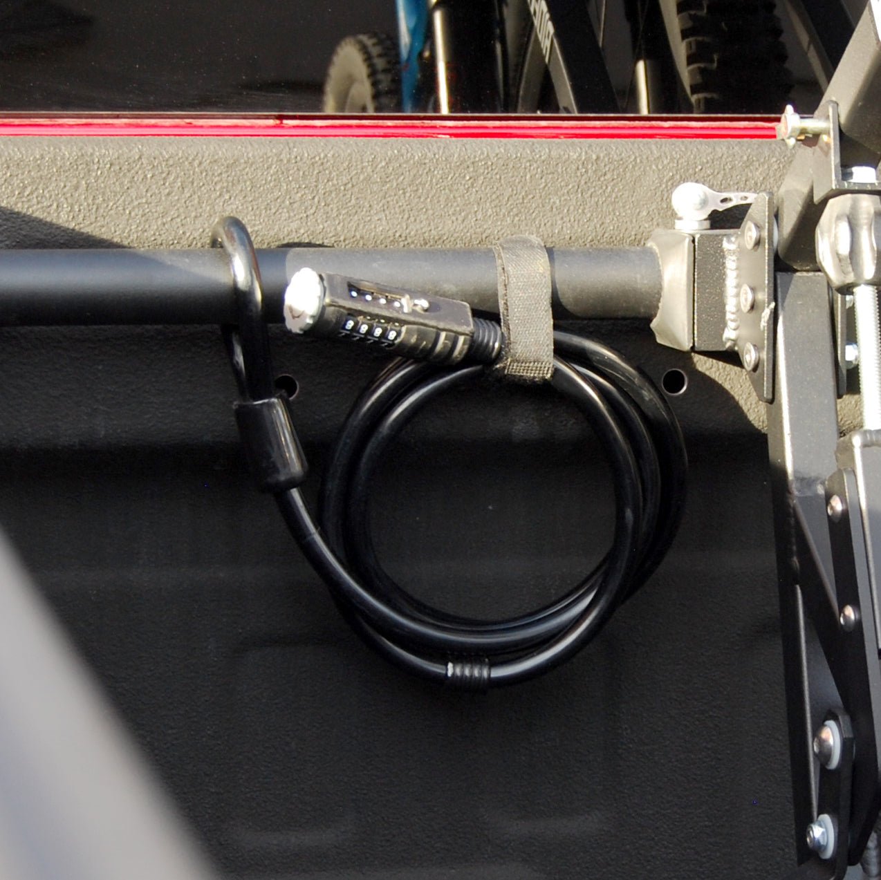RIDE88 Cable Lock for locking bicycles in your truck bed coiled up and attached to a crossbar.