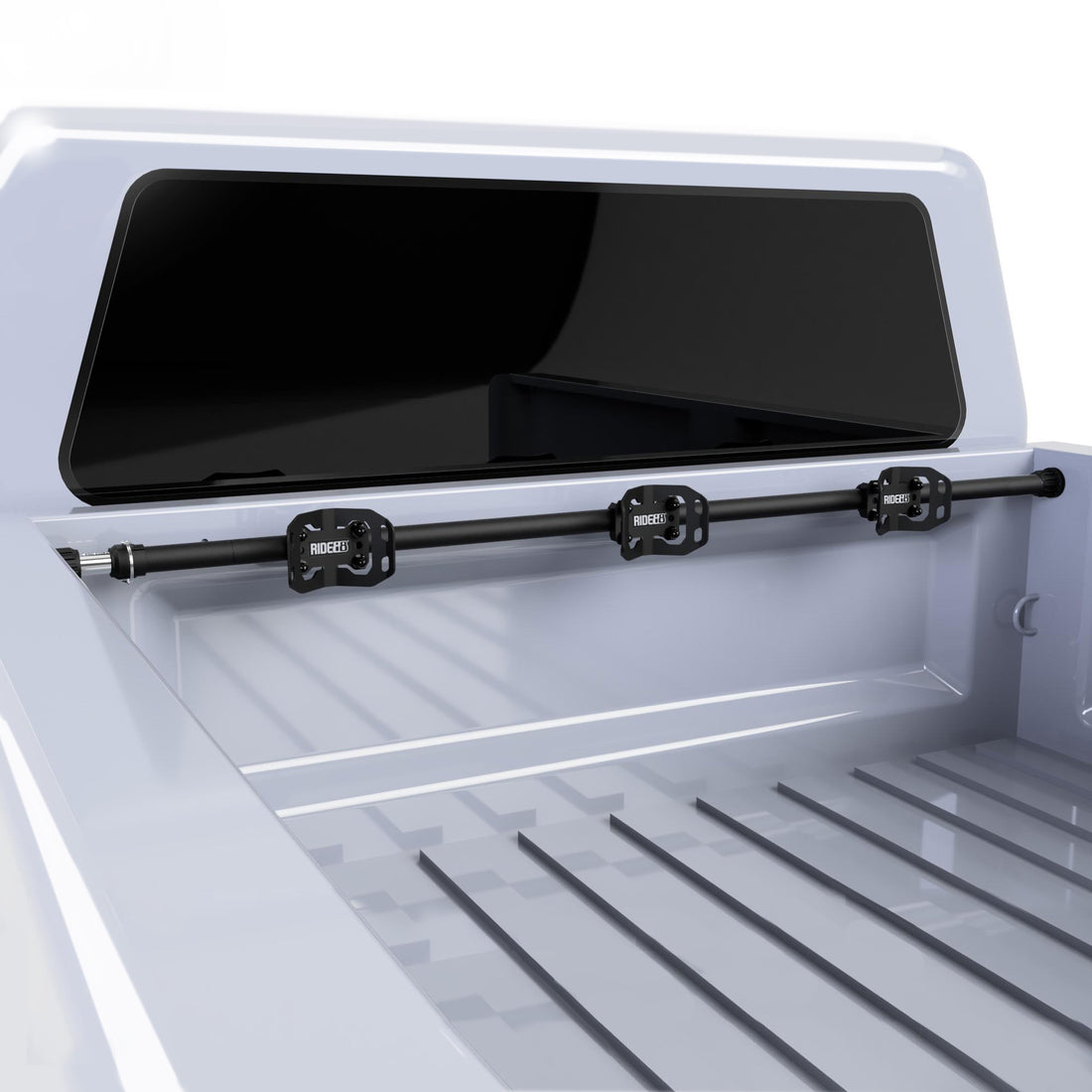 A RIDE88 Telescopic Crossbar Cinch Rack, consisting of three Wheel Chocks and a Telescopic Crossbar, mounted to the bed of a truck.