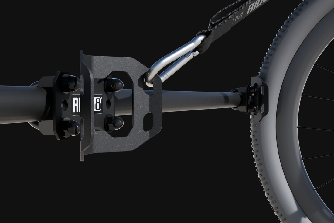 2 RIDE88 Wheel Chocks mounted on a crossbar, one with a bike attached.