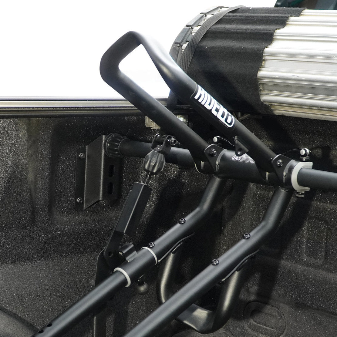 RIDE88 QR3 bike rack with telescopic crossbar mounted in a Ford F-150 truck bed using a bed cover adapter, allowing clearance for a tonneau cover.