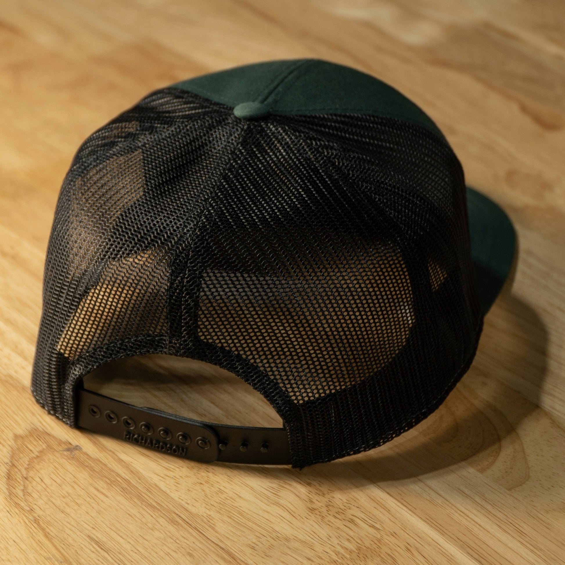 RIDE88 green and black trucker hat with brown leather patch logo reading “RIDE88 Ultimate Truck Bike Racks,” featuring flat bill and mesh back design.