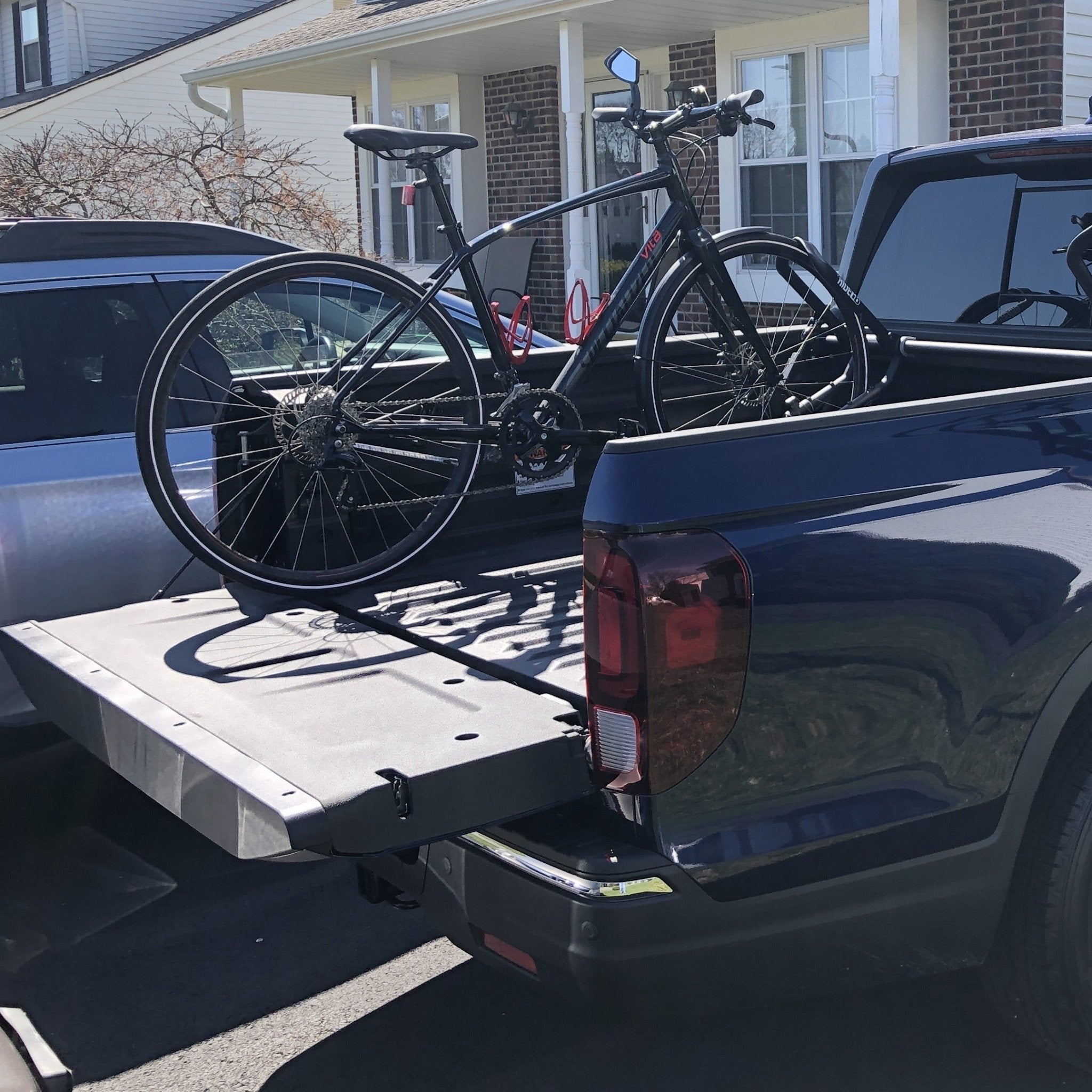 Bike mounted to the bed of a truck using the QR3 bike rack for Honda Ridgeline.