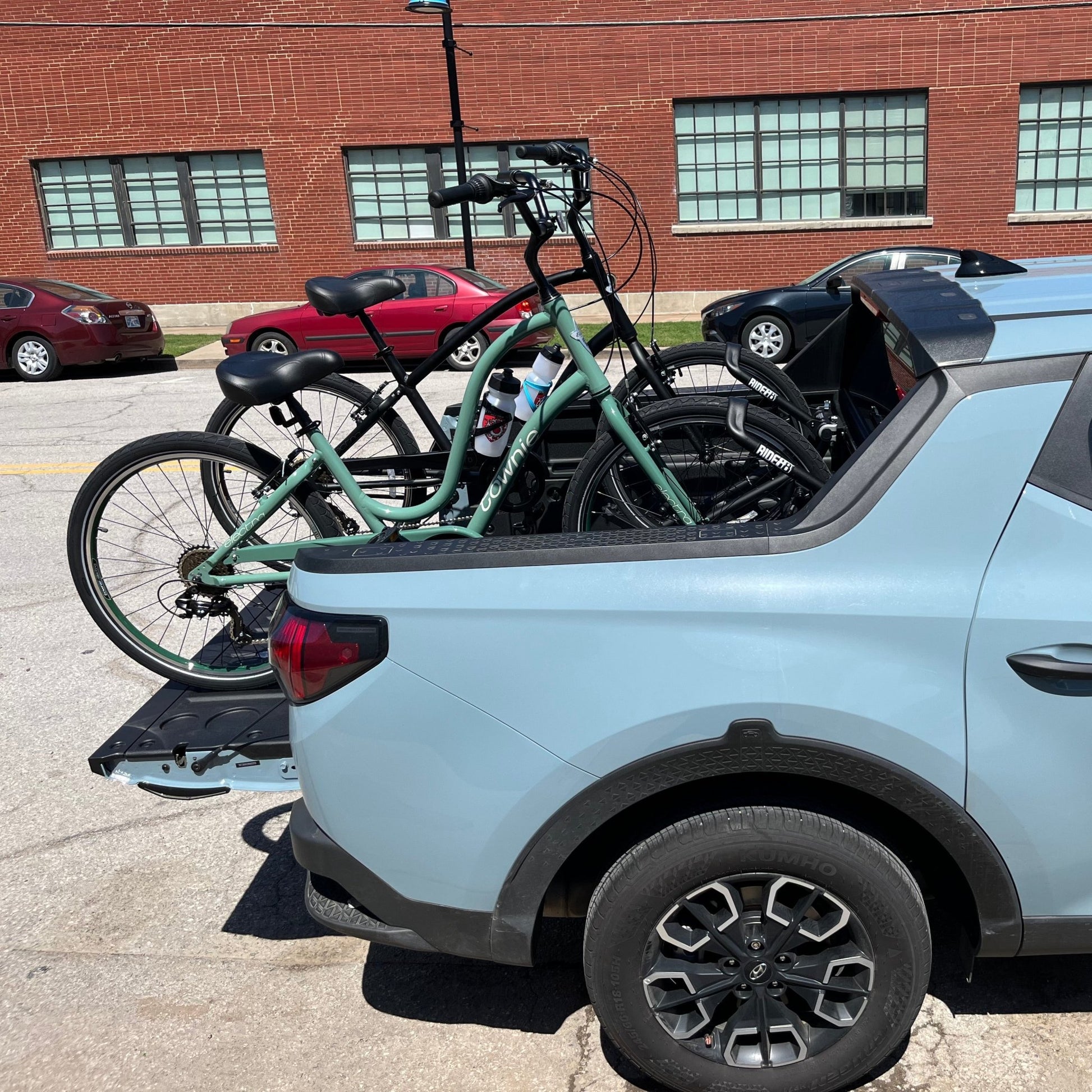 Two bicycles mounted to the bed of a truck using QR3 bike racks for Hyundai Santa Cruz