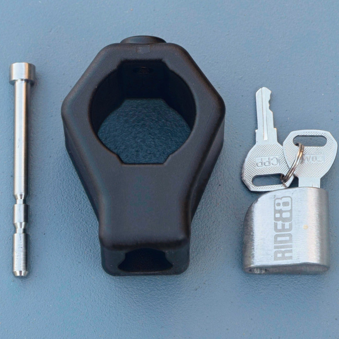 RIDE88 stainless steel locking pin, key, and fiberglass-reinforced nylon lock-housing set for securing Telescopic Crossbar, precision-machined for truck bed bike rack security.