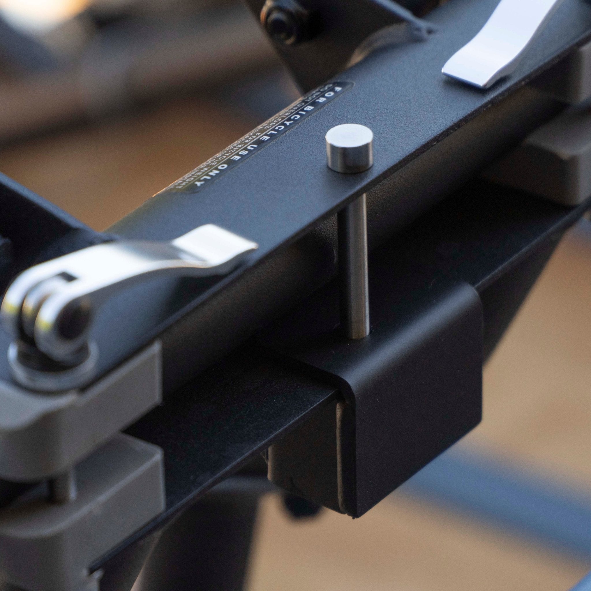 RIDE88 Premium QR3 Rack Lock rear view, showing the pin reaching behind the crossbar and into the lock housing out the bottom.