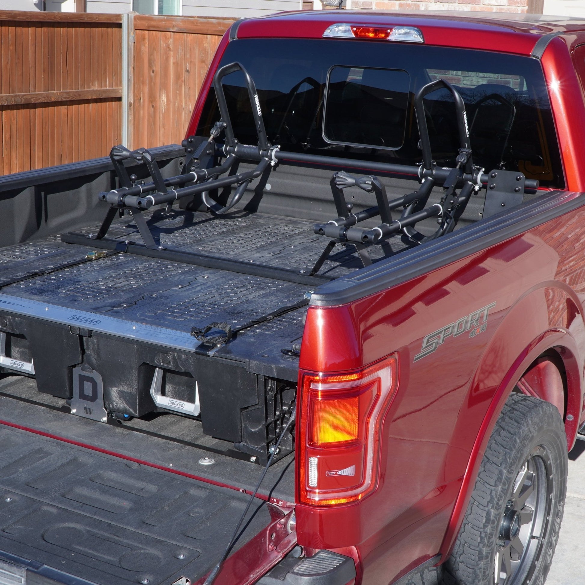 Two QR3 Bike Racks for DECKED truck bed storage box using a crossbar, utility track, and custom brackets.