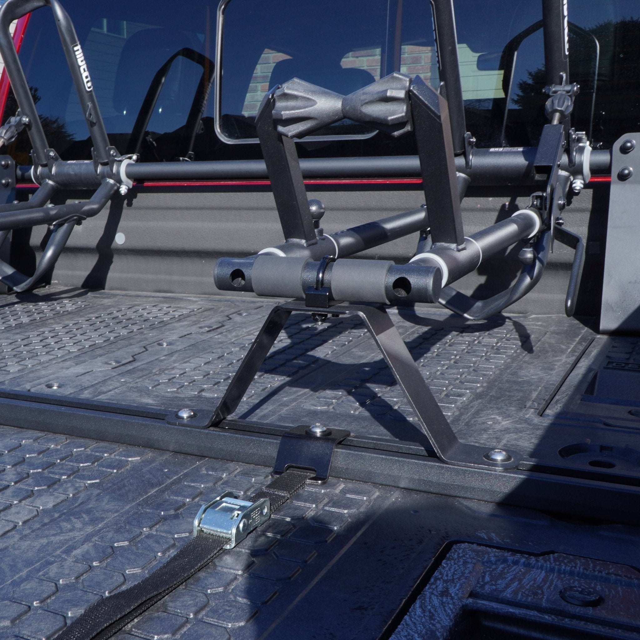 Close view of two QR3 Bike Racks for DECKED truck bed storage box using a crossbar, utility track, and custom brackets.