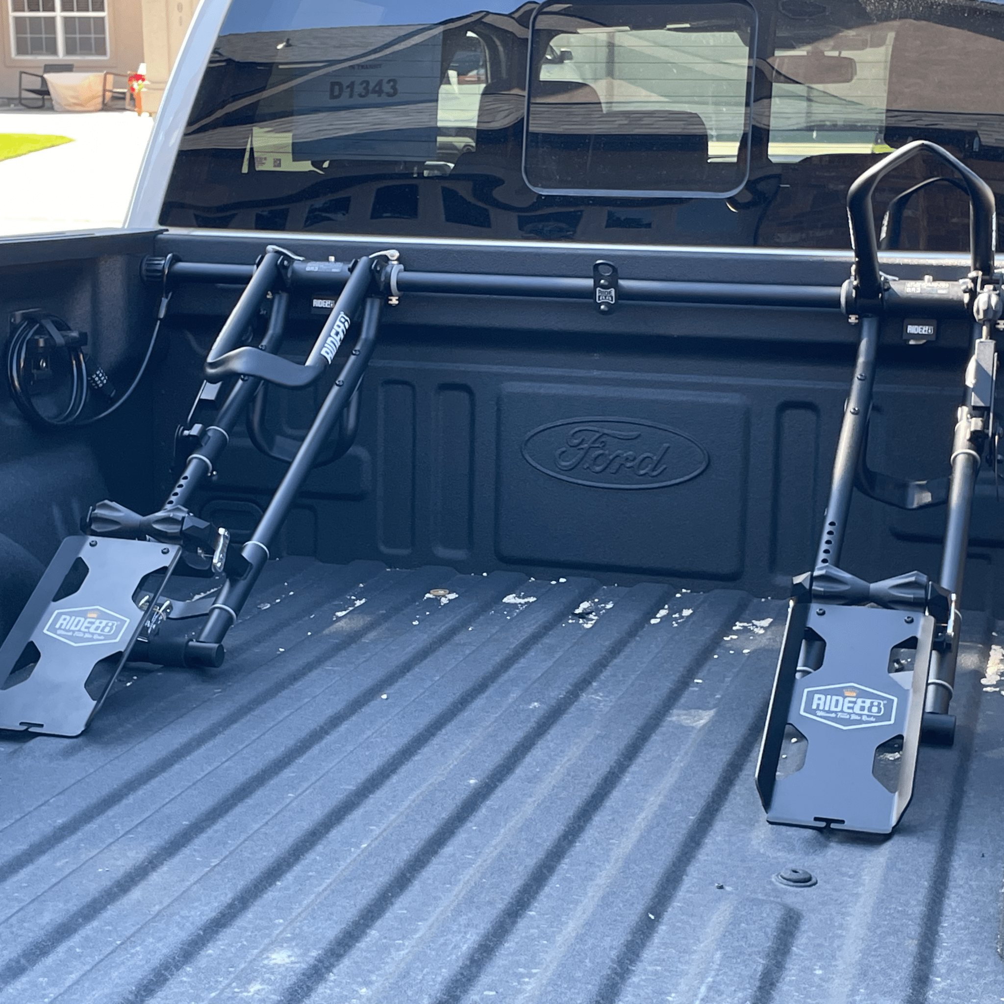 Two RIDE88 QR3 Bike Racks in a truck bed with QR3 Mini Ramps attached for easy bike loading.