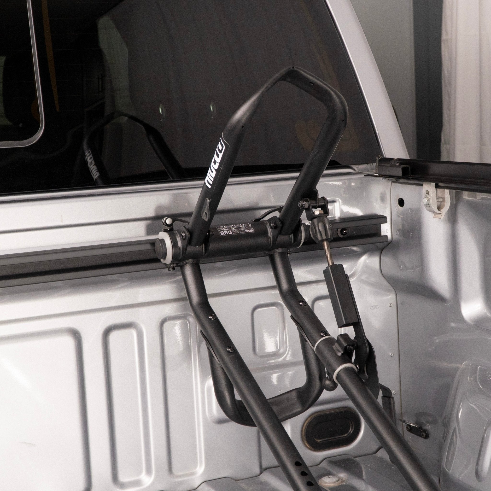 RIDE88 QR3 bike holder mounted to utility track in a pickup truck bed.