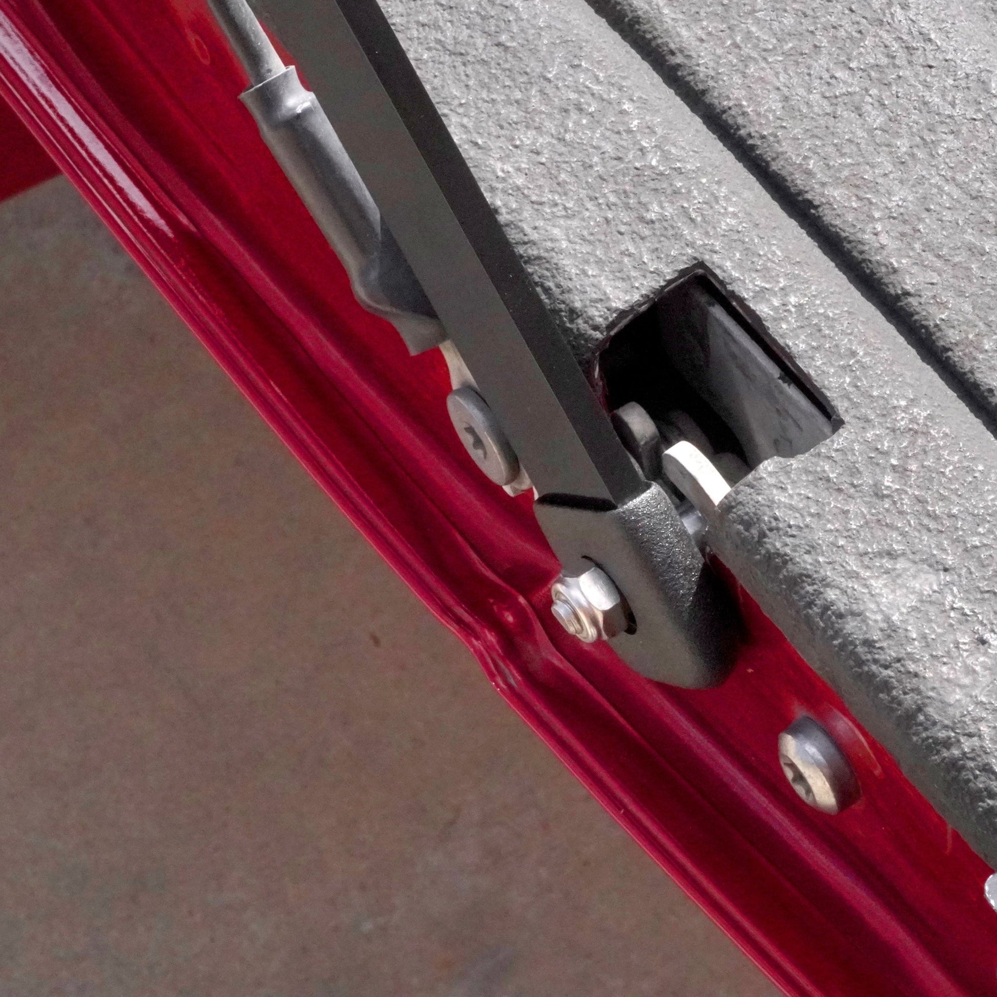 Close up of the RIDE88 Tailgate Boss tailgate support bar mounted in the latch of the tailgate.