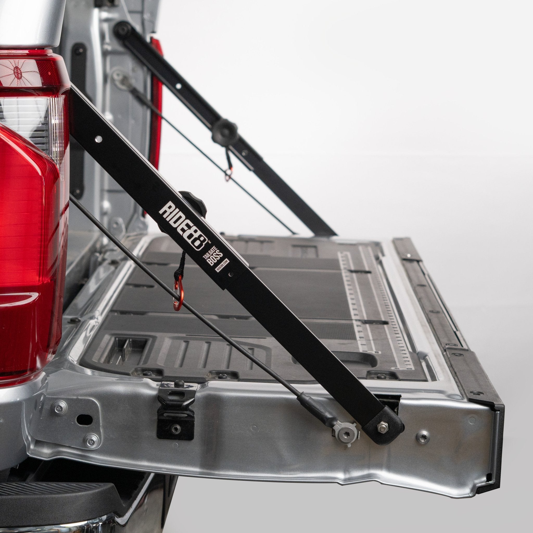 RIDE88 Tailgate Boss Pro truck bed support bars mounted on a pickup, securing tailgate from bouncing.