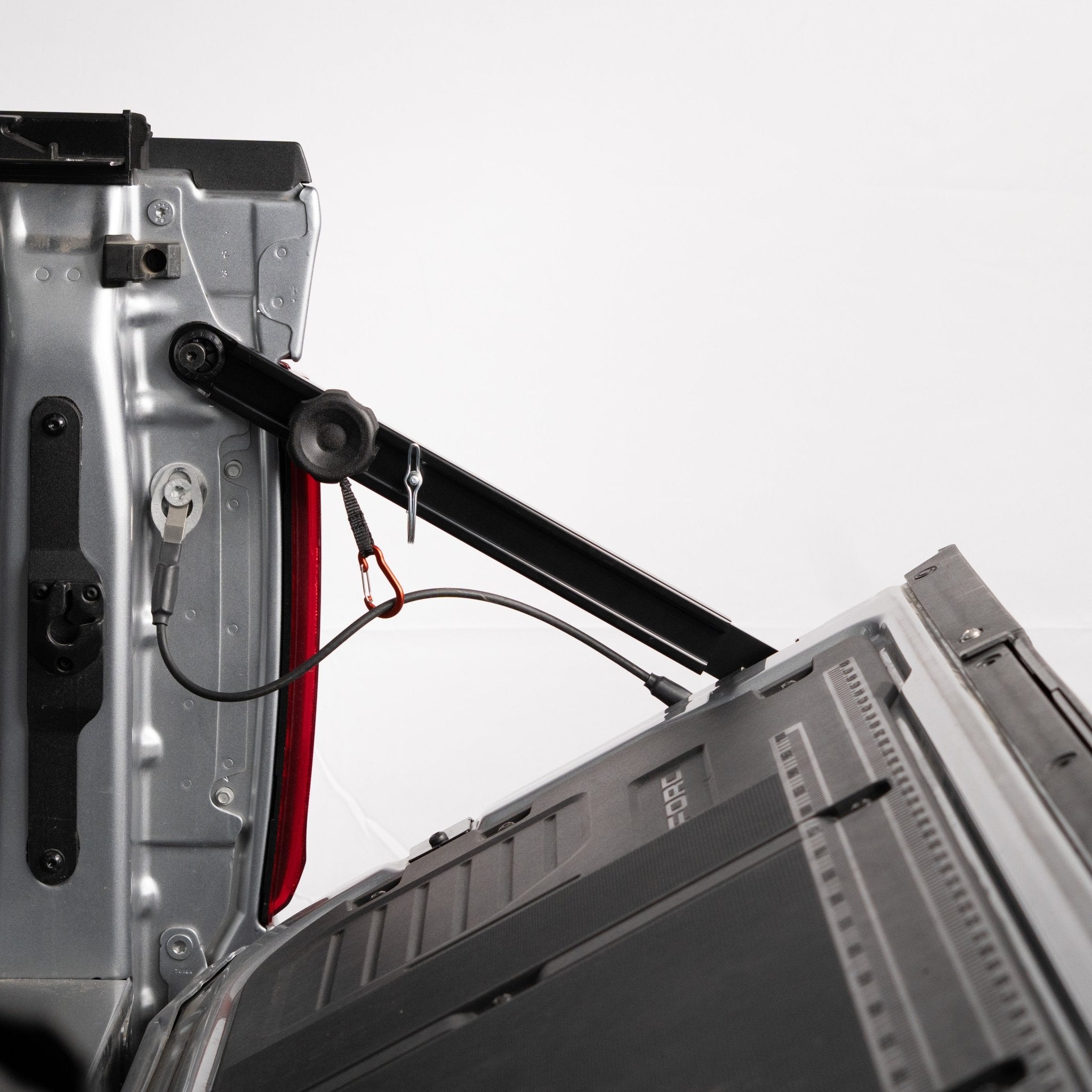 RIDE88 Tailgate Boss Pro-Kit truck bed support bar mounted on a red pickup, holding it at a 45-degree closed angle.