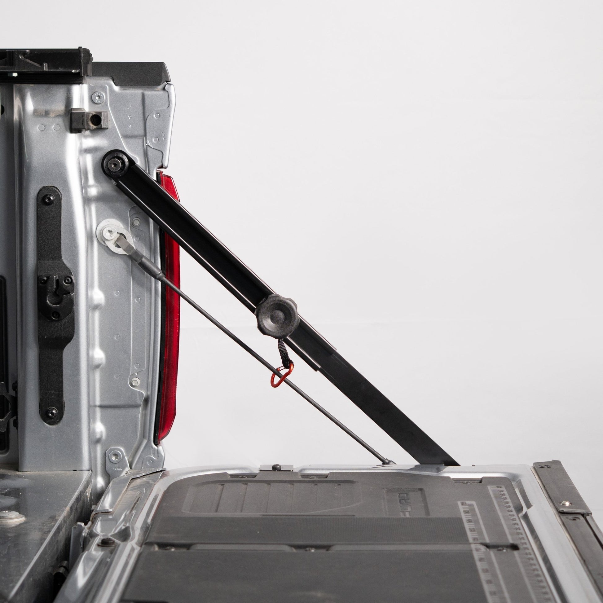 RIDE88 Tailgate Boss truck bed support bar mounted on a pickup, securing tailgate from bouncing.