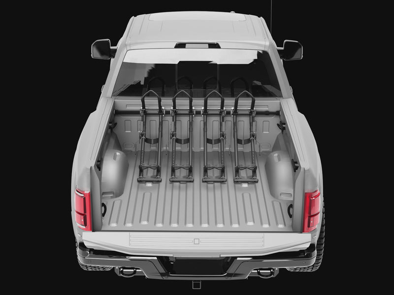 A truck bed showing multiple QR3 bike racks being added and their ability to move left to right for best placement.